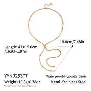 Macro detail of gold stainless steel bead chain with lobster clasp and extension chain