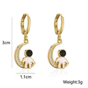 Macro view of 18K gold plated moon astronaut earrings with detailed size and weight specs