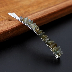 Detail of natural grey crystal stone inlay on a silver metal handmade hair pin clip