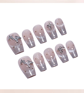 Macro view of coffin nails with cat eye gradient finish and 3D butterfly rhinestones