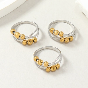 Three-piece stainless steel anxiety rings set with gold rotating beads and cutout design