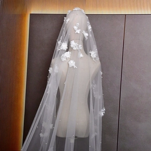 Detail of 3M bridal veil with 3D floral appliqués and pearls on soft white tulle