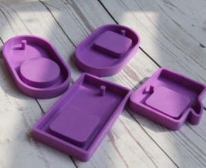 Detailed view of four purple silicone molds for DIY resin tags and landscape pendants