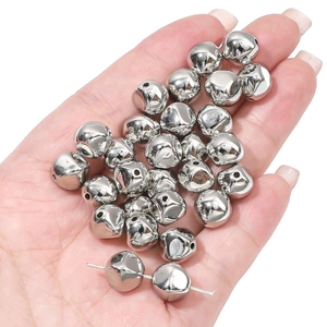 Close-up of metallic silver star beads held in hand for DIY jewelry making and crafts