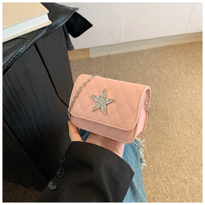 Detailed view of pink quilted kids crossbody bag with sparkling rhinestone star