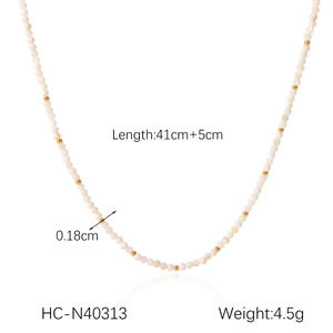 Detail view of 41cm beaded necklace showing 0.18cm white and gold beads with measurements