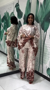 Detail view of the floral print pattern and silky fabric on the long sleeve two-piece set
