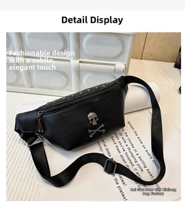 Close-up of black leather waist bag featuring silver skull emblems and metal rivet details