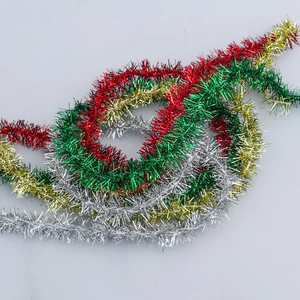 Detail view of colorful metallic Christmas tinsel garlands in red green gold and silver