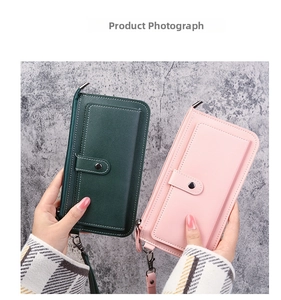 Close-up of pink and green long wallets with textured PU leather and wrist straps