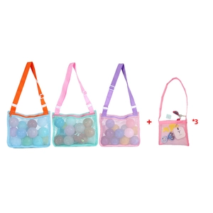 Detail view of colorful mesh beach bags in various sizes with sand toys inside