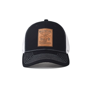 Detail view of a leather deer patch on a breathable mesh trucker cap with wild nature theme