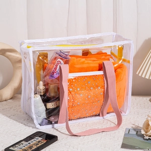Detailed view of waterproof PVC beach bag with pink straps and orange star pattern insert