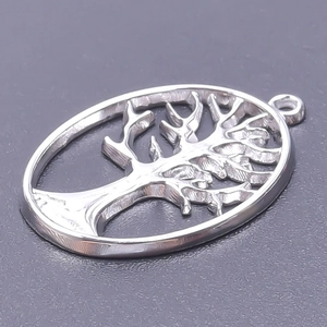 Detailed view of silver oval tree of life pendant with hollow design and polished finish