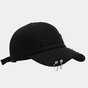 Black denim baseball cap with silver metal rings and distressed ripped street style details