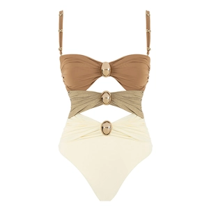 Detail of three-tone cutout one-piece swimsuit with metallic gold buckle accents