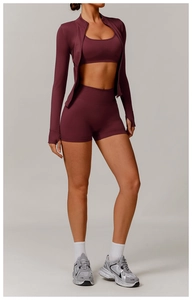 Close-up of seamless burgundy yoga set with thumbhole sleeves and ribbed high waist detail