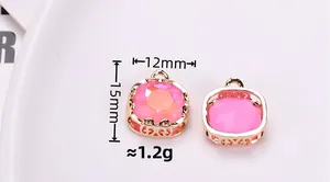 Close-up of pink faceted square gemstone pendant with golden filigree edge 12x15mm