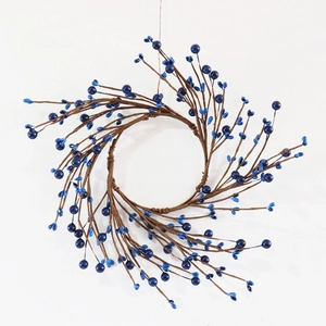 Detailed close-up of handmade blue berry wreath with dark brown realistic rustic branches