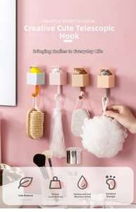 Detail showing four cute animal-shaped retractable wall hooks for home organization
