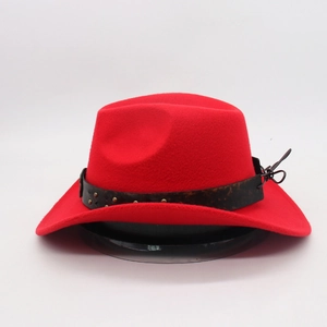 Detail of red wool cowboy hat featuring a leather band with metal bull head rivets