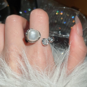 Detail of French vintage multi-layer pearl ring with zircon accents worn by model