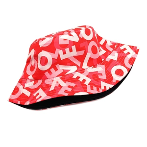 Close-up of red bucket hat with white and pink LOVE letter prints on breathable canvas