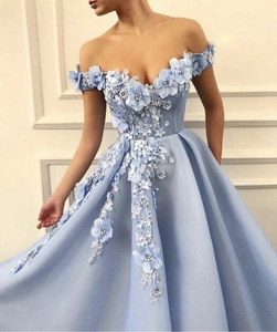 Close-up of elegant 3D floral appliques and lace embroidery on a light blue evening gown