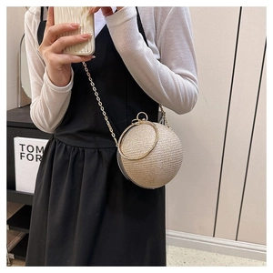 Detail of champagne gold sphere evening bag with glitter finish and ring handle