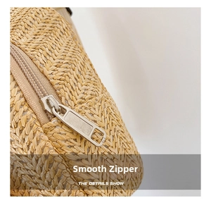 Close-up of the smooth metal zipper and woven texture on this cute straw crossbody bag