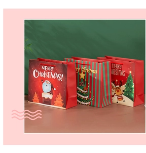Three festive Christmas paper gift bags with Santa Claus and tree patterns for holiday wrapping