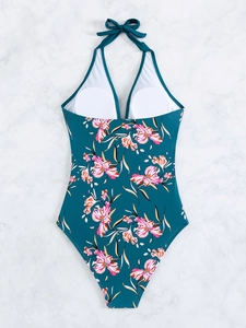 Detail of teal halter neck swimsuit featuring floral print and removable chest pads