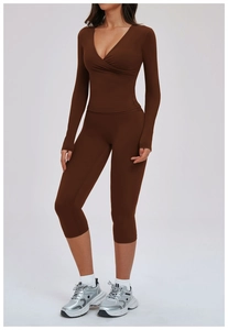 Deep brown yoga set featuring cross-over long sleeve top and high-waist cropped leggings
