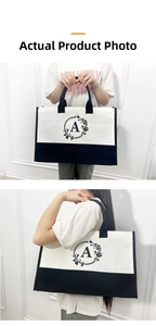 Detailed view of large canvas tote bag with black flower print and handle texture