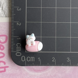 Detailed scale view of a 1.5cm miniature white resin cat charm for DIY crafts