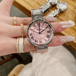 Women's vintage silver steel watch with pink Roman numeral dial shown on wrist