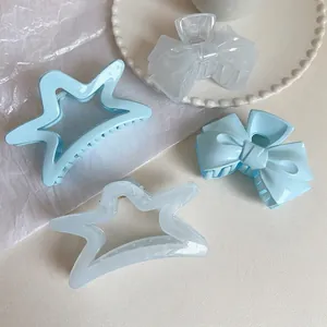 Light blue cream jelly star and bow hair claw clips set in acrylic for summer styling