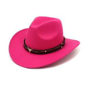 Detail of rose red western cowboy hat with cattle head metal ornament and studded band