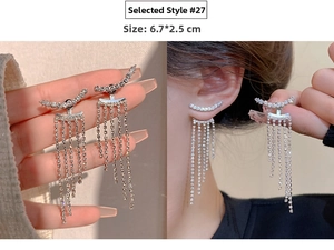 Close-up of 6.7x2.5cm silver tassel earrings with sparkling rhinestones and vertical fringe