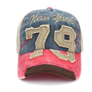 Detailed close-up of vintage denim baseball cap with New York 79 embroidery and zigzag stitching