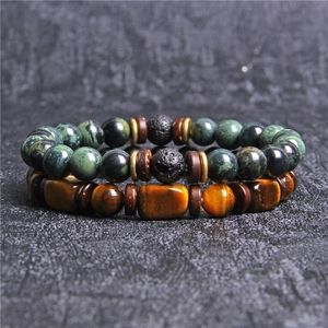 Men's natural tiger eye and lava stone beaded bracelet set on dark textured background