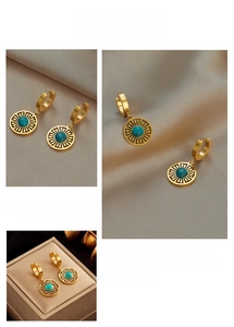 Detailed view of vintage gold hollow sunburst earrings with round turquoise stones