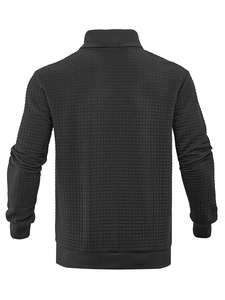 Macro detail of the black waffle knit texture on the back of this men's sweatshirt