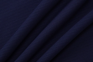 Close-up of navy blue ribbed knit fabric texture on a French style backless dress