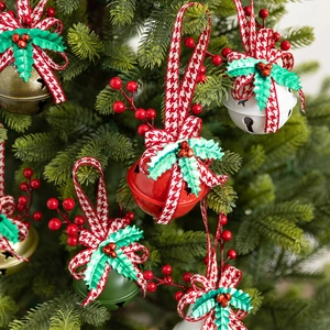 Christmas tree bells with plaid bows and red berries for festive holiday decoration