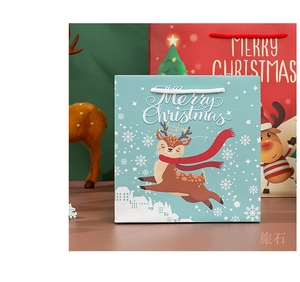 Blue Christmas paper gift bag with reindeer motif and white snowflake patterns