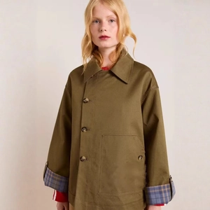 Olive green women's coat with blue plaid lining details and large dark buttons