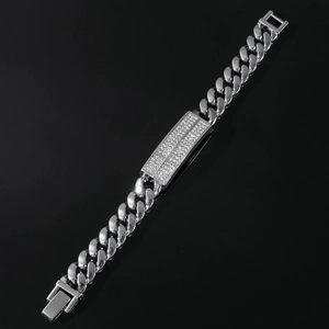 Detail shot of silver Cuban link bracelet with iced-out rectangle plaque and metal clasp