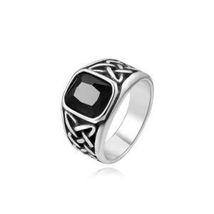 Detailed side view of Celtic knot pattern on silver vintage ring with black square stone