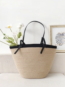 Minimalist beige cotton woven tote bag with black handles for beach and holiday